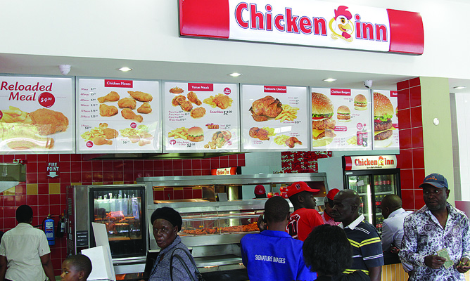 Customers being served at a Chicken Inn