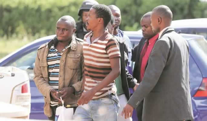 Some of the four suspects who were arrested last Friday following an abortive bid to bomb the First Family’s Alpha Omega Dairy Farm being led by detectives into the Harare Magistrates’ Courts yesterday. — (Picture by Lee Maidza)