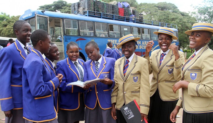 Ordinary Level students from Bradley High School have time to read and chat while waiting to board the bus back to school from Harare yesterday - Picture by Kudakwashe Hunda
