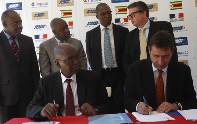 NMB Bank managing director Mr Benefit Washaya (seated left)