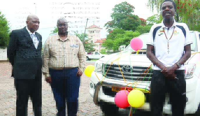 Mighty warriors coach Shadreck Mlauzi (right) speaks after being handed over keys to a Toyota Hilux, while Wicknell Chivayo (centre) and Philip Chiyangwa look on (Picture by NewsDay)