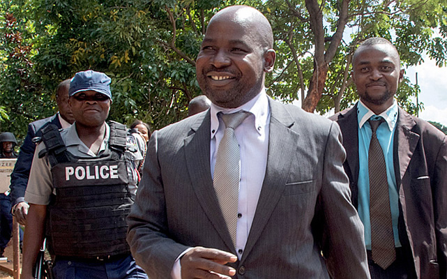 Zimbabwe's chief prosecutor Johannes Tomana (C) arrives at the Harare Magistrates court