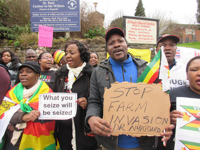 Encouraged by widespread coverage in the British press, more than 60 exiled Zimbabweans and supporters last Friday took part in a protest outside a clinic in Nottingham run by a Zimbabwean immigrant doctor who has seized one of the last white-owned farms in Zimbabwe.