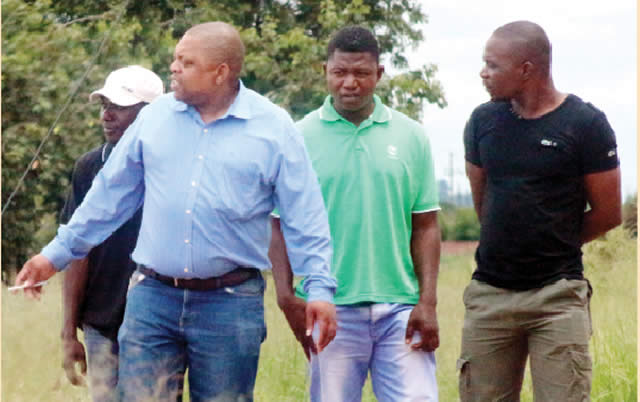 TM Cowdray Park manager Shepherd Msipha (left), makes indications to detectives after the break-in yesterday