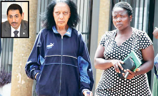 Kuwait Embassy official Brenda Avril May (left), who is accused of human trafficking, is escorted by a police detective as she arrives at the Harare Magistrates’ Courts yesterday. (Picture by Tawanda Mudimu)