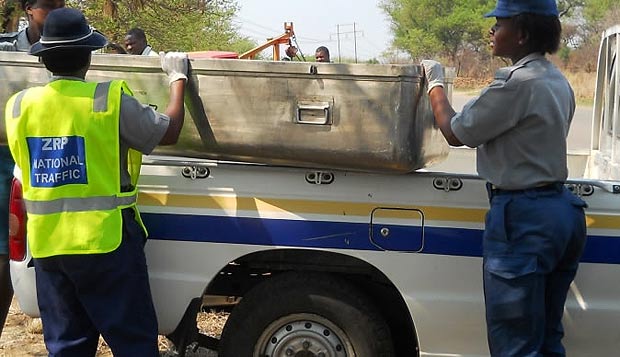 File picture of traffic police loading a metal coffin