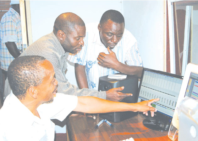 Bothwell Nyamhondera (left) demonstrates how studio equipment works to Daiton Somanje (centre) and Alick Macheso at the launch of Last Power Media in 2008
