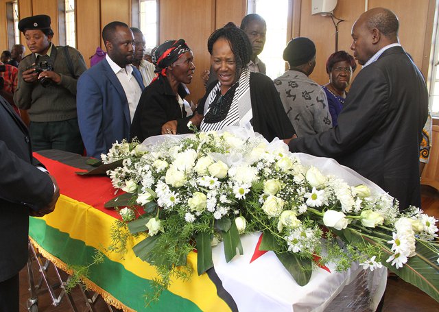 Mrs Tapuwa Muchemwa (stripped top), wife of Rtd Brig-Gen Felix Muchemwa weeps over the coffin bearing her husband's body. Pictures by Tawanda Mudimu