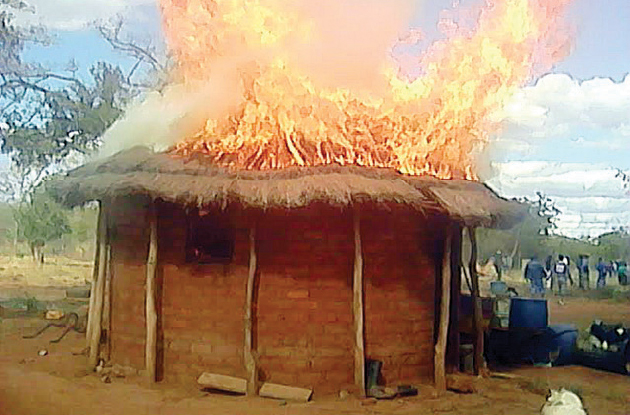 A hut at Marble Ndlovu’s homestead burns after angry villagers set it alight