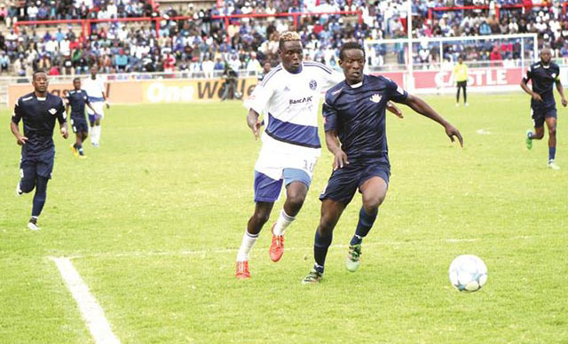 CHECK MATE . . . Dynamos striker Roderick Mutuma (left) challenges How Mine defender Kudzai Chideu for the ball during yesterday’s match at Barbourfields. — (Picture by Paul Mundandi)