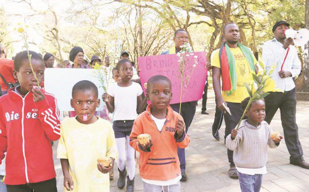 Itai Dzamara's children take part in the commemoration march for their missing father