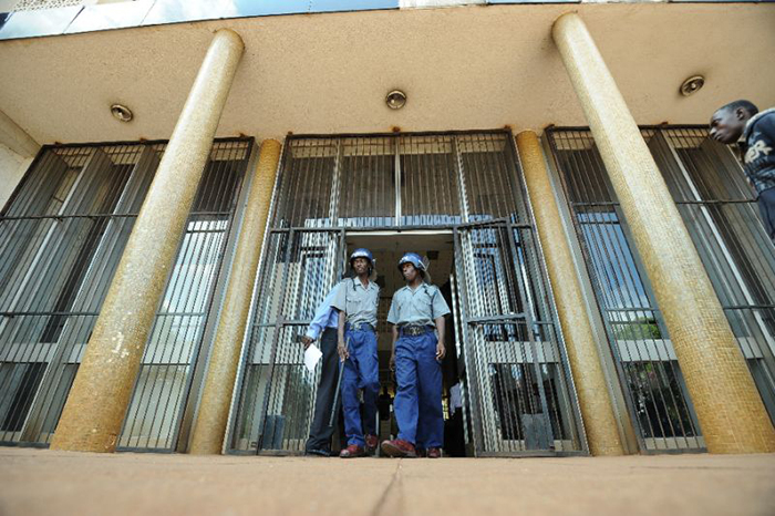 Zimbabwean riot police patrol outside Harare Magistrates Court