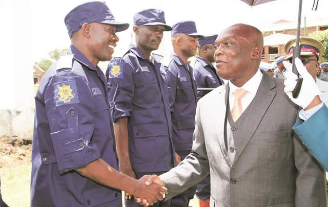 Police Commissioner-General Augustine Chihuri (right) greets Superintendent Augustine Zimbili during a parade for Sudan-bound ZRP officers on UN peacekeeping duties
