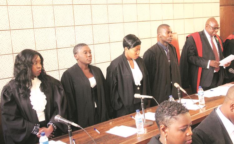 Chief Magistrate Mr Mishrod Guvamombe (right) swears in magistrates (from left) Rumbidzai Dzumbira, Edith Kakuruwo, Nyasha Marufu and Joshua Mawere at the Harare Magistrates’ Court on Friday. — Picture by Munyaradzi Chamalimba