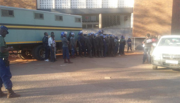 Riot police preparing to load the activists into a prison truck- while lined up to prevent photos being taken