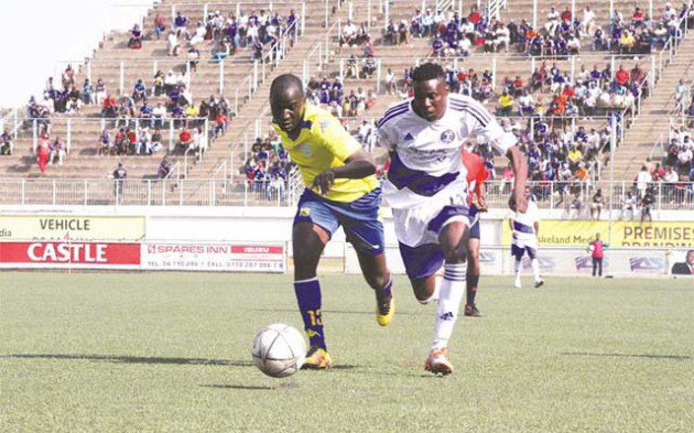 Dynamos striker Denver Mukamba (right) tussles for possession with Chapungu United’s defender Blessed Mbawarira during yesterday’s Castle Lager Premiership soccer match at Rufaro