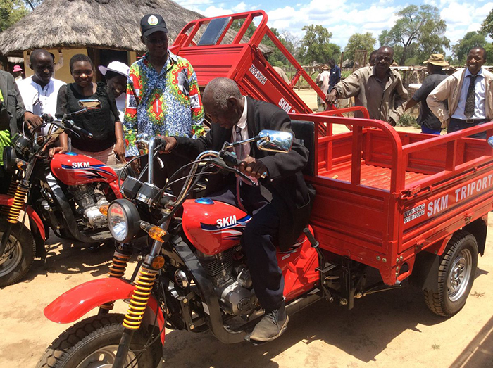 Jonathan Moyo dishing out motorbikes for headman and bicycles for village heads in Tsholotsho