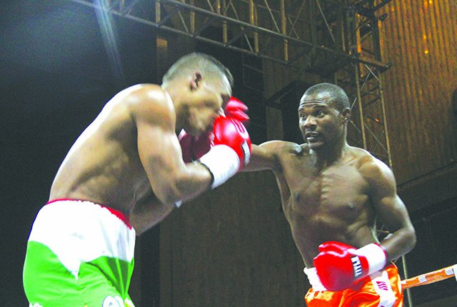 Zimbabwe boxing superstar, Charles Manyuchi (right), connects with a thunderous right that shakes his Colombian opponent Jose Agustin Julio Feria during the first round of their World Boxing Council sanctioned non-title fight at the Harare International Conference Centre last night. — Picture by John Manzongo