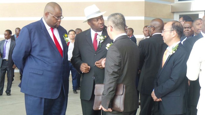 Local Government Minister Saviour Kasukuwere and Choppies Zimbabwe director Siqokoqela Mphoko speak to unidentified dignitaries. Picture by Believe Nyakudyara