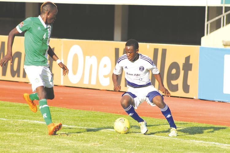 HOT PROPERTY . . . Highly-rated midfielder Brett Amidu (right) works his way past CAPS United defensive pillar Dennis Dauda during the reverse fixture of the Harare Derby at the National Sports Stadium where he provided two assists for the Glamour Boys’ three goals in the six-goal thriller. — (Picture by Kuda Hunda)
