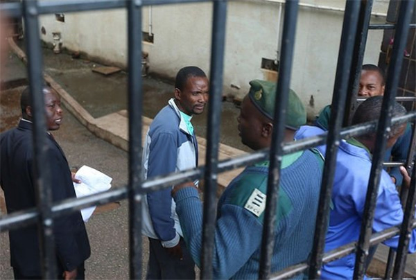 Pastor Mugadza being led away by prison guards