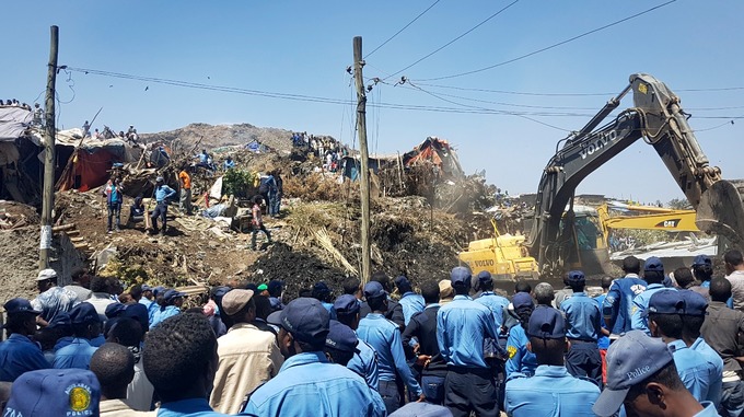 Police and emergency workers pictured at the scene of the rubbish landslide. Credit: AP