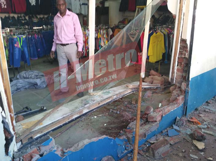 Two passengers were on Friday injured when a Kombi driver evading arrest rammed into a clothing shop along Innez Terrace Street