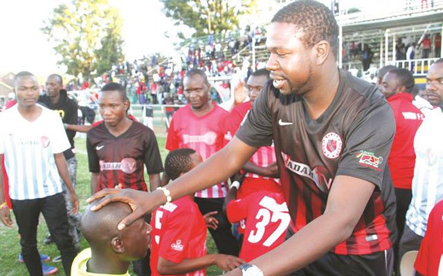 HAPPY FAMILY . . . Yadah Stars owner and technical adviser Prophet Walter Magaya blesses his goalkeeper Tafadzwa Dube amid a wave of celebrations at Morris Depot yesterday following their thumping victory over Triangle. — (Picture by Kudakwashe Hunda)