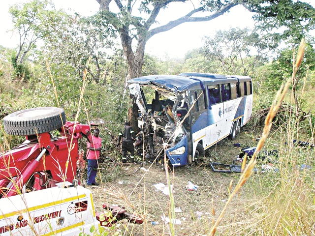 A tow truck recovers the wreckage of a King Lion bus that veered off the road and hit a tree killing 45 people in Nyamakate, Hurungwe – Picture by Walter Nyamukondiwa