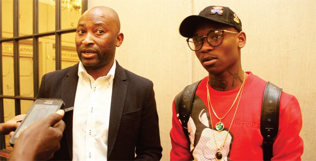 CLEARING THE AIR…Zimbabwe football legend Peter Ndlovu (left), who is also Mamelodi Sundowns team manager, addresses the local media in Harare in the company of Warriors star Khama Billiat who was assessed by national team doctors who ruled him out of Sunday’s 2019 AFCON qualifier against Liberia.