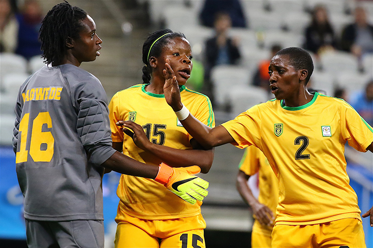 Lynett Mutokuto (2) and Rutendo Makore (15) praise Lindiwe Magwede for another big save. (Photo ANN ODONG / For Excelle Sports)