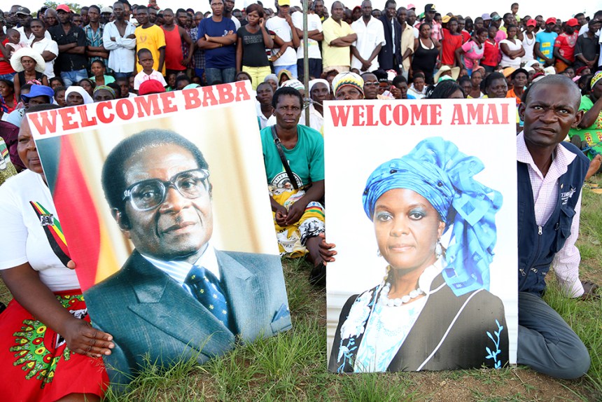 Zanu-PF supporters display posters bearing President Mugabe and First Lady Grace Mugabe’s portraits during a Zanu-PF rally at Chipadze Stadium in Bindura on Friday – (Picture by Believe Nyakudjara)