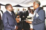 Huge send-off for Gogo Msika President Mugabe hands over the national flag to Mbuya Maria Msika’s son Shelton, while First Lady Dr Grace Mugabe looks on during the national heroine’s burial at the National Heroes Acre yesterday. — (Picture by John Manzongo)