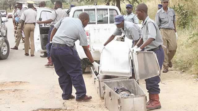 File picture of police putting a body in a metal coffin