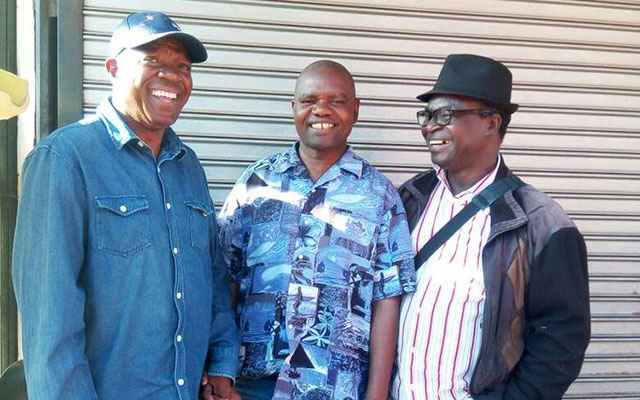 Kireni Zulu (centre) poses for a picture with Mitchell Jambo (left) and Jonah Moyo (right) after their arrival from South Africa