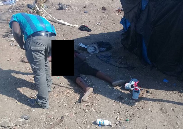 A police officer inspects Kedah’s body after he was shot in Beitbridge yesterday