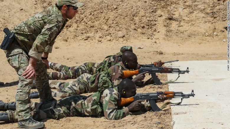 A U.S. Army Special Forces weapons sergeant observes a Niger Army soldier during marksmanship training in Diffa, Niger, in February 2017