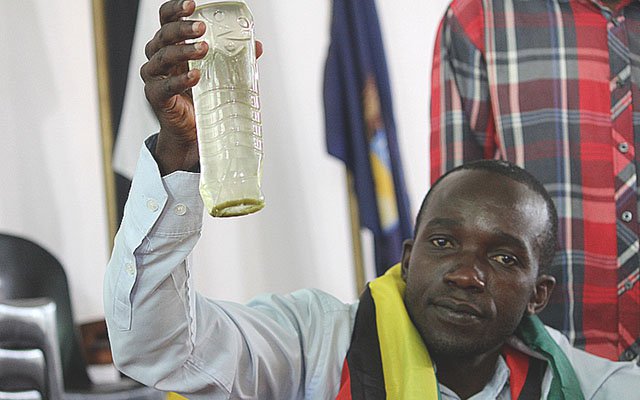 A Harare resident holds aloft a bottle containing water that is being supplied by council during a Press conference in the capital. — (Picture by Innocent Makawa)