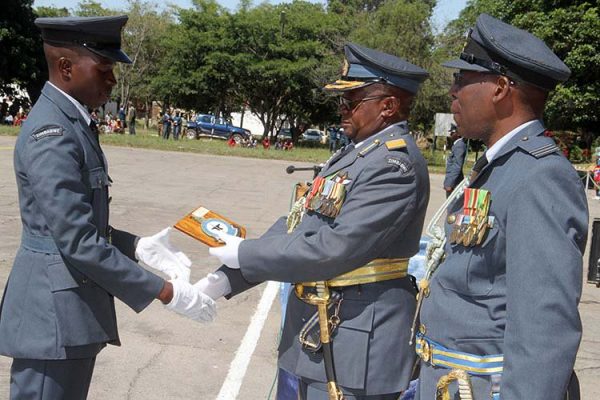 Air Vice Marshal Shebba Shumbayaonda hands-over the Overall Best Student award to Corporal Gumbo