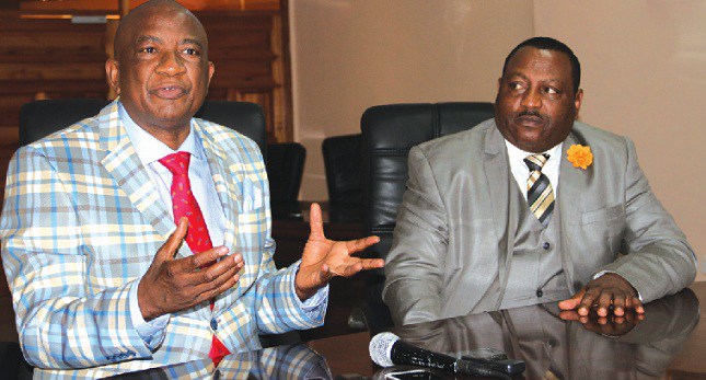 Zifa president Philip Chiyangwa, left, stresses a point during a press conference while his deputy Omega Sibanda looks on