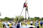 11 000 volts kill copper cable ‘thief’ Fire brigade officers wrap the body of the man who was electrocuted in Queen’s Park East in Bulawayo yesterday. (picture by Obey Sibanda)