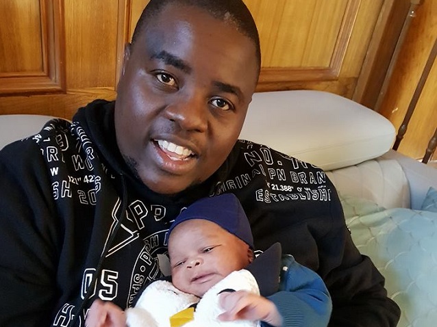 Wicknell Chivayo with his child