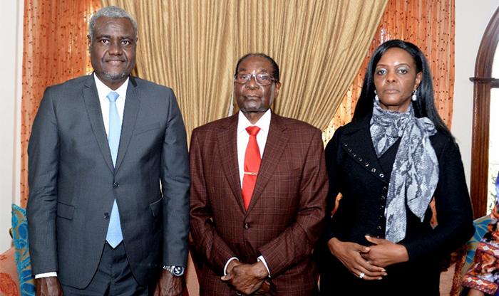 Moussa Faki Mahamat seen here with former president Robert Mugabe and his wife Grace