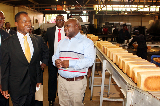 Lobels Bulawayo branch manager Dumisani Mhlanga stresses a point to the Reserve Bank of Zimbabwe governor Dr John Mangudya during a tour of Lobels Bread