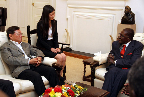 Then President Robert Mugabe meets R and F company president Mr Zhang Li while the interpreter Ms Yi Chen(centre) looks on at State House in Harare.-(Picture by Tawanda Mudimu)