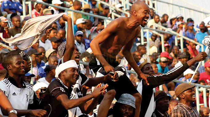 RAW BOUNDLESS PASSION . . . If there is any picture that really captures the great romance between Highlanders and its fans, then it has to be this one, captured by the Gemazo photographer at Rufaro, where this former ZINARA executive, the late Augustine Moyo, shirtless and pregnant with emotion, screams after Bosso scored against DeMbare (Picture by Gemazo)