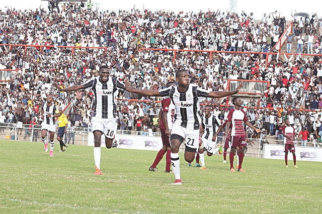 Highlanders defender Peter Muduhwa (right) celebrates his equalising goal against Shabanie Mine with teammate Newman Sianchali at Barbourfields Stadium