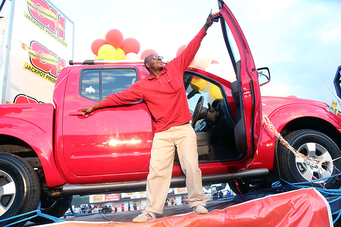 OK Grand Challenge winner, Mr Todd Mutukwa (43) of Harare’s Glen View 7 suburb, has a feel of his new Nissan Navara at Borrowdale race course in 2015 – Picture: Believe Nyakudjara