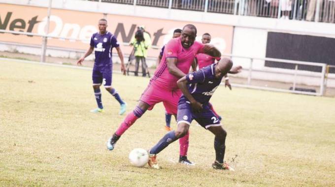 POWER PLAY . . . Herentals’ Innocent Benza (in red strip) tussles for possession with Dynamos midfielder James Marufu at Rufaro yesterday