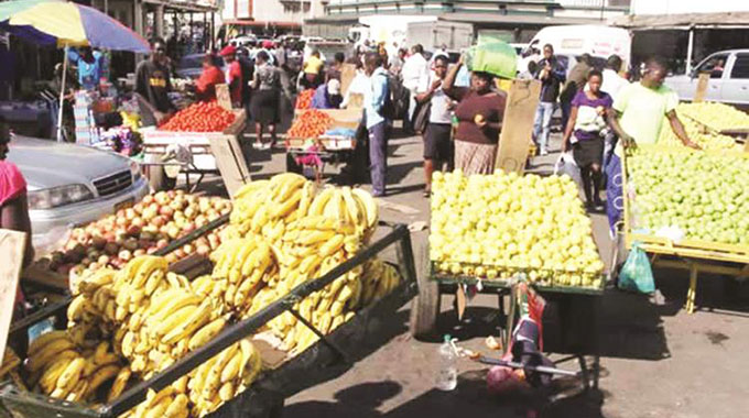 This image shows vendors selling an assortment of fruits and vegetables on pavements and road islands in Harare, rendering roads virtually impassable. The vendors have also been accused of blocking parking space, prejudicing City Parking of revenue